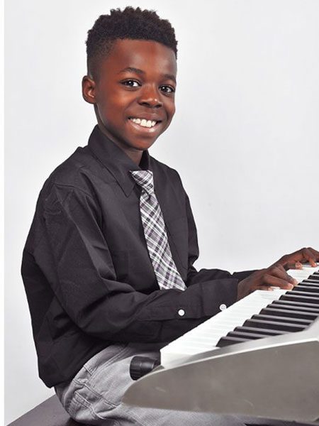 black kid playing piano